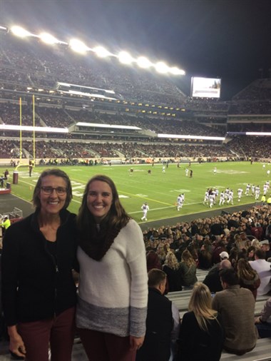 Caitlin with her mom at a football game