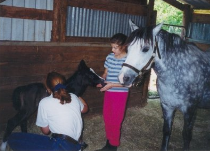 Chelsea, as a child, with her mother and her horse Sparkle. 