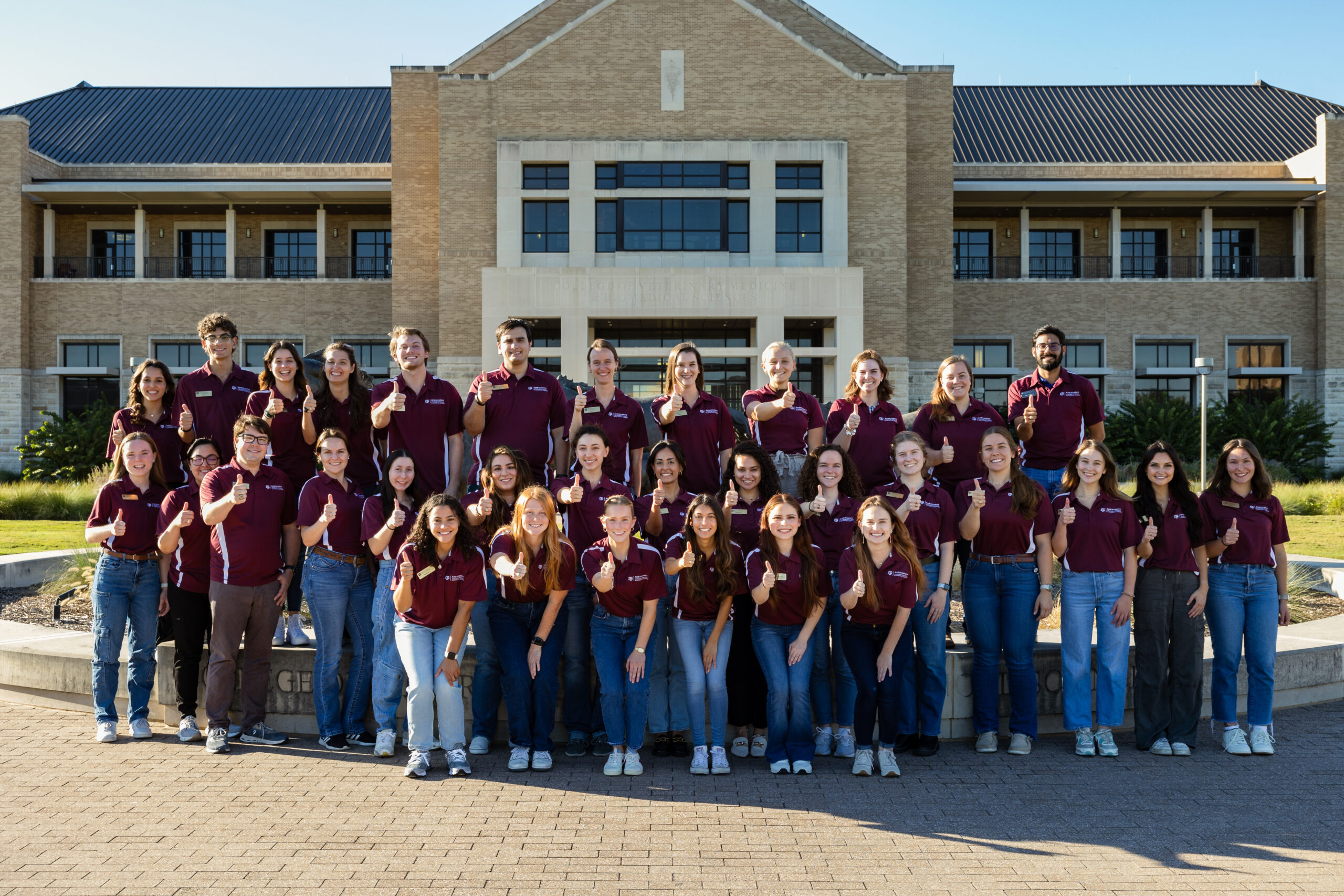 Ambassadors in front of the VBEC with Gig'Em hand signs
