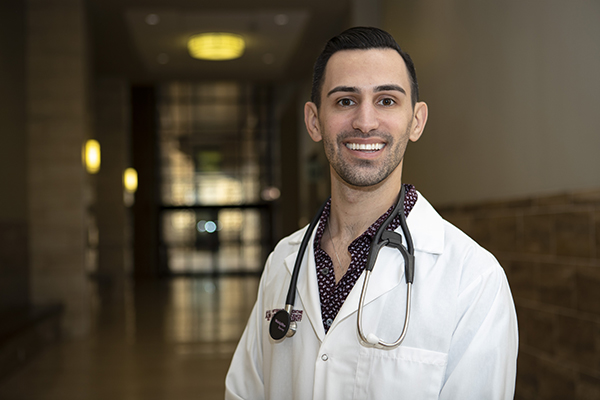 Alex Golden with stethoscope and white coat