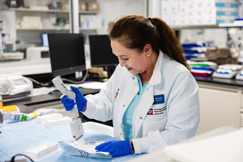 a veterinary technician performs a test in the lab