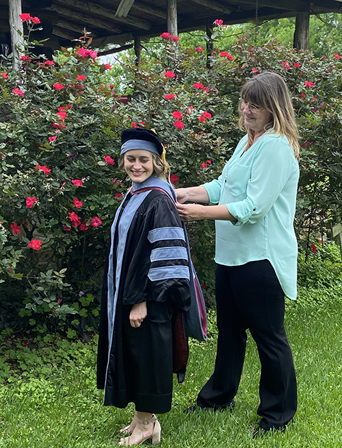 Ashton Plummer in graduation regalia