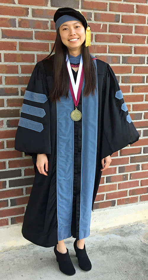 Anne Serra in graduation regalia