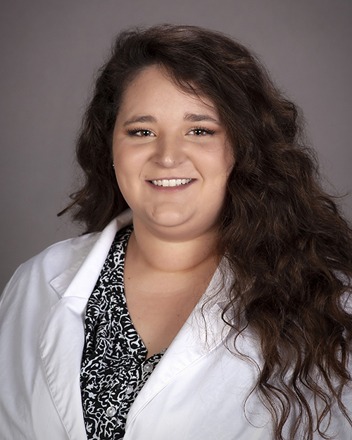 Chelsea Kosar in white coat