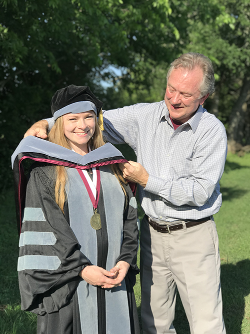 Emily Crews in graduation regalia