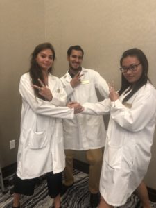three graduate students got their white coats