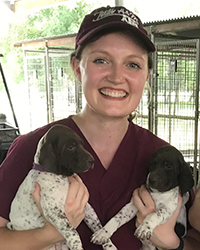 Rache lBusselman with two puppies