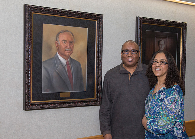 Dr. Cleveland Manley and Dr. Dana Johnson next to a painting of former dean Dr. George C. Shelton