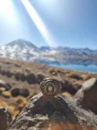 Aggie ring in foreground overlooking mountains of Chilean landscape