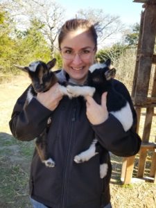 Katrina LaCaze holds two baby goats