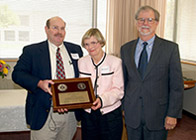 Vera Stewart is recognized with a plaque from Dr. George Lees and Dean H. Richard Adams.