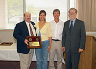 Laura and Danny Weaver receive special thanks and a plaque from Dr. George Lees and Dean H. Richard Adams.