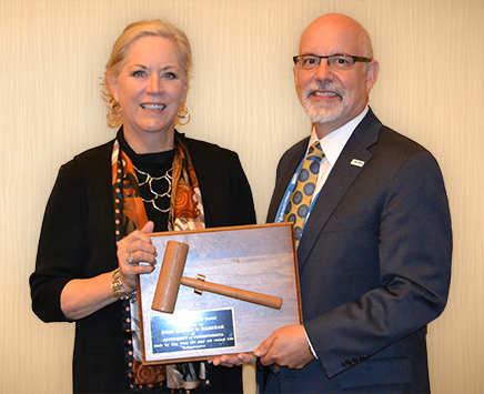 Outgoing AAVMC President Dr. Trevor Ames (right) hands over the gavel to Dr. Eleanor M. Green.