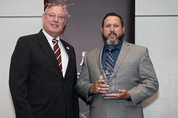 Dr. David Lunt and Dr. Scott Dindot holding the Texas A&M innovation award