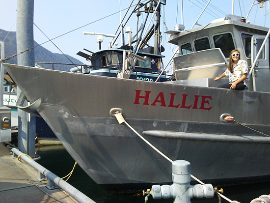 Linda sits on the edge of the Hallie while it is docked at a harbor