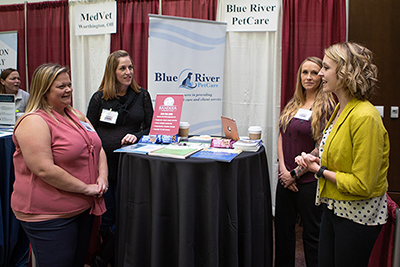 Taylor Sheffield discusses opportunities with the Blue River PetCare booth at the CVM job fair