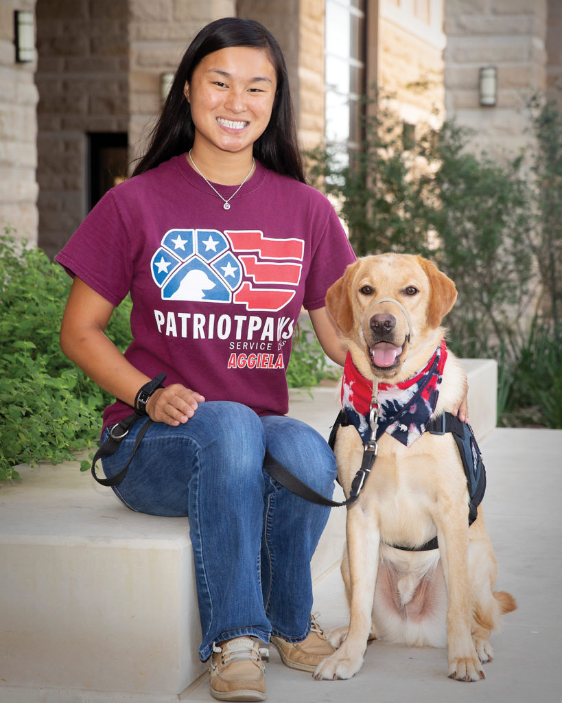 Angelica in a Patriot PAWS shirt with a yellow lab