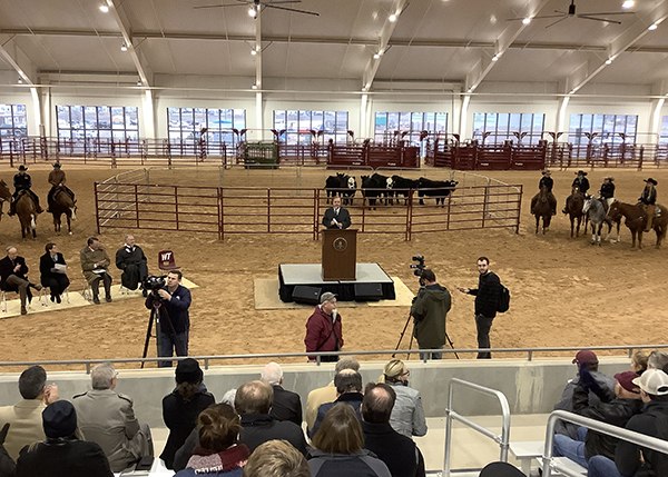 Texas A&M University System Chancellor John Sharp speaks in an area with cattle and horses