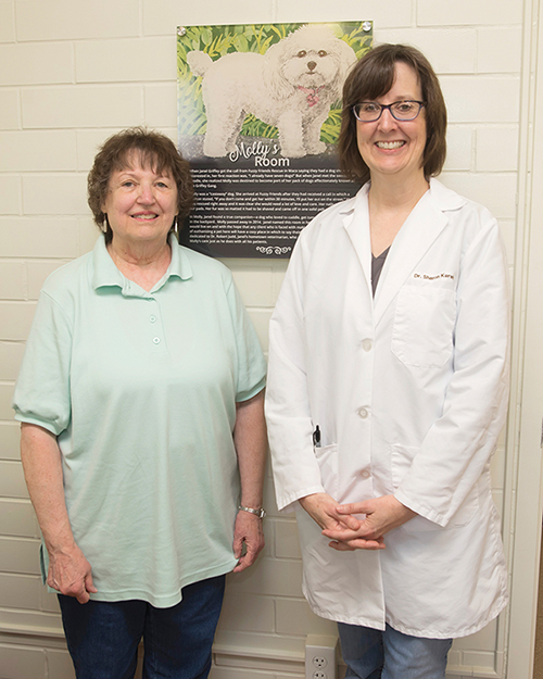 Janel Griffey and Dr. Sharon Kerwin in front of a sign commemorating Molly