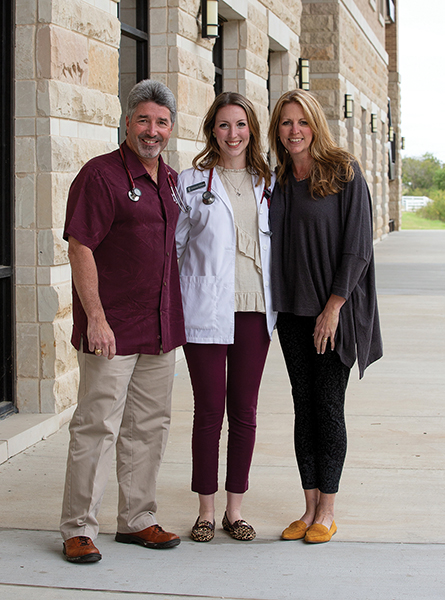 Amanda and her parents in the VBEC courtyard