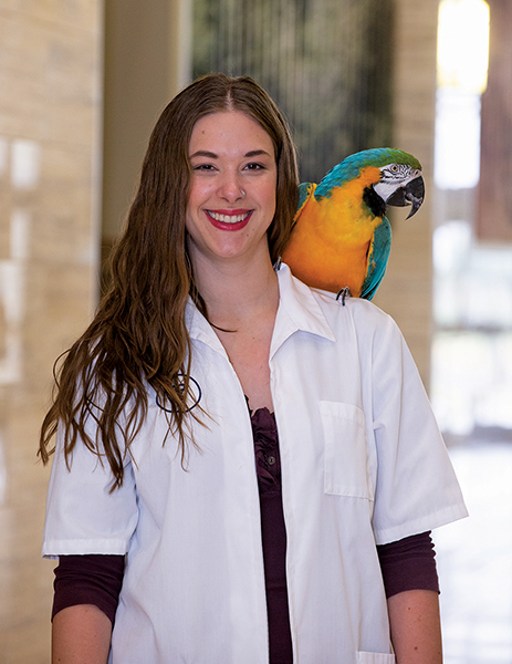 Jillian Villalva with a parrot on her shoulder