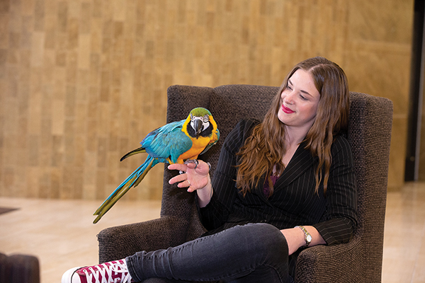 Jillian Villalva holding a parrot