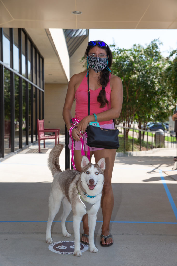 A woman and a husky stand in the Small Animal Hospital Entrance