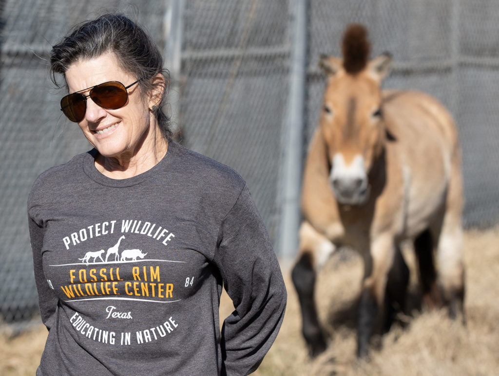 Dr. Alice Blue-McLendon with a Przewalski's horse in the background