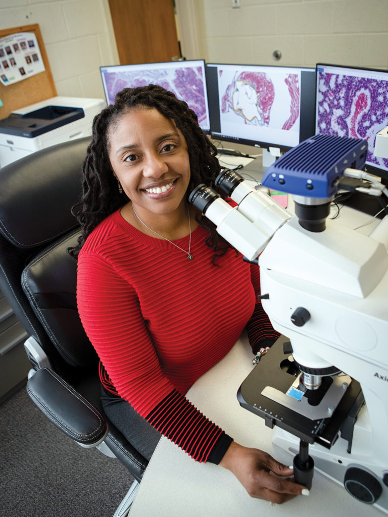 Dr. Yava Jones-Hall at the microscope