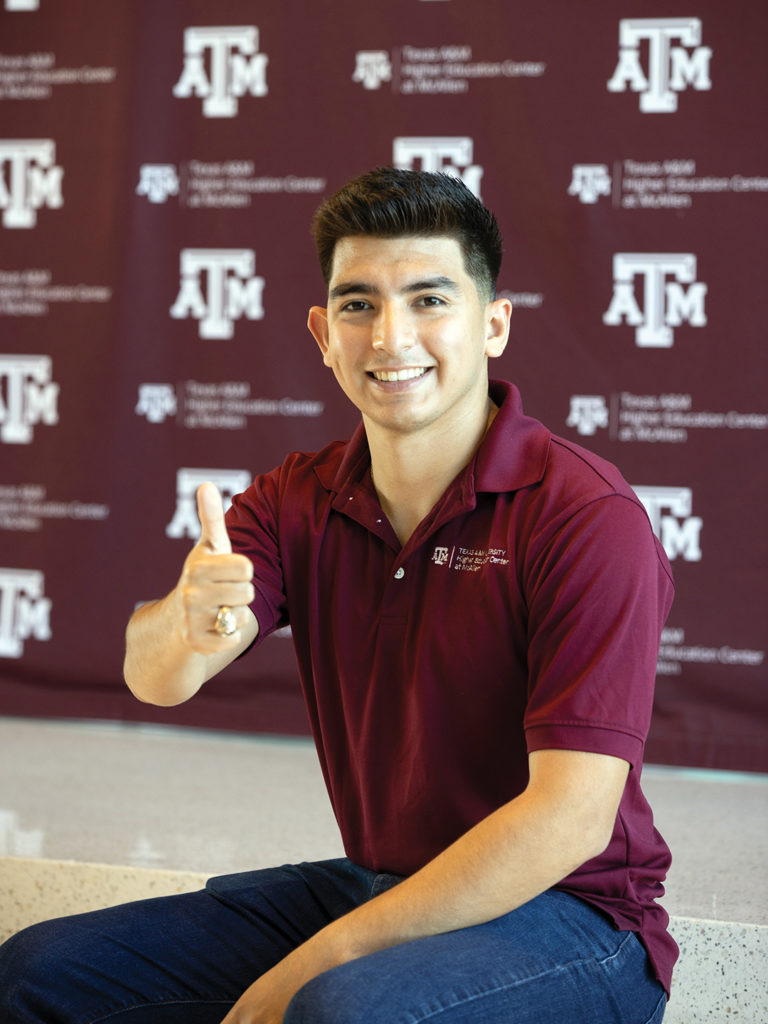 Lopez in a maroon shirt giving thumbs up