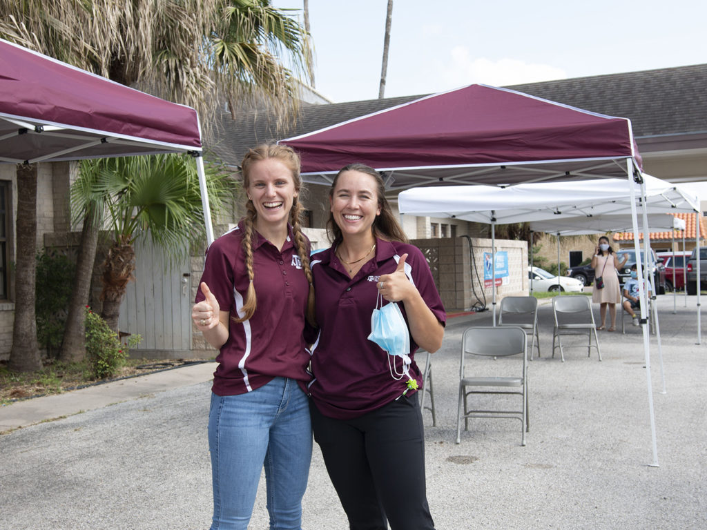 two Texas A&M nutrition students give thumbs up at Operation Lone Star