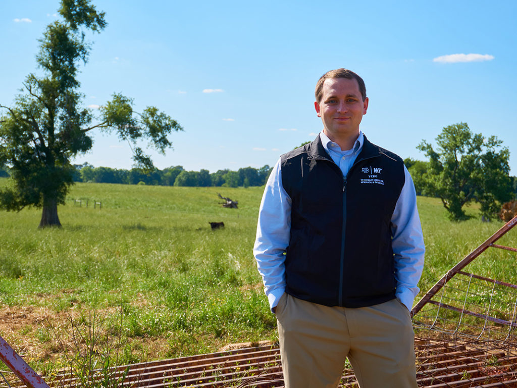 Dr. Matthew Scott in front of a field