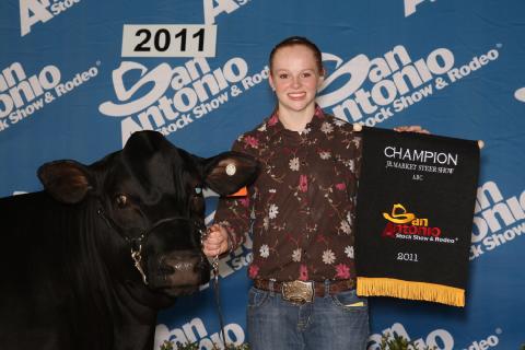 young Terry with a black steer and an award plaque