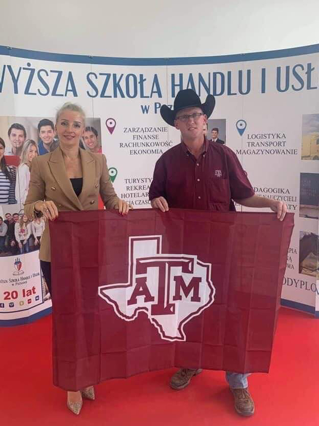 Mazurkiewicz and Gorska holding a Texas A&M flag 