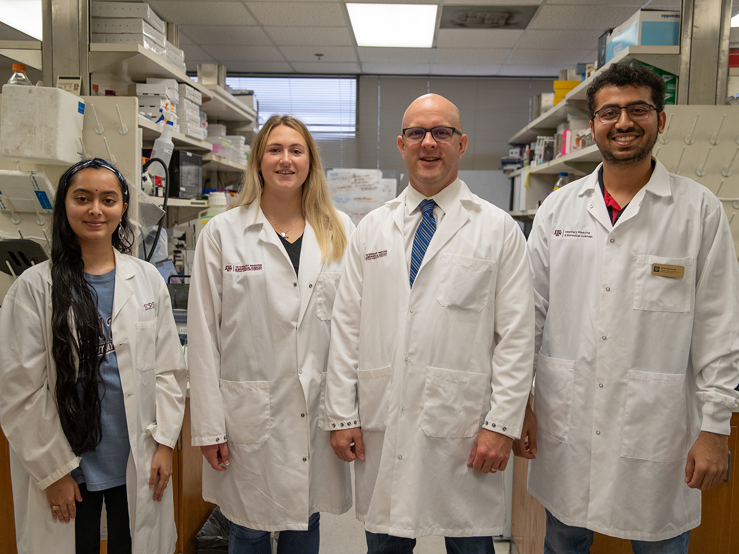 Four members of the Golding lab in white coats