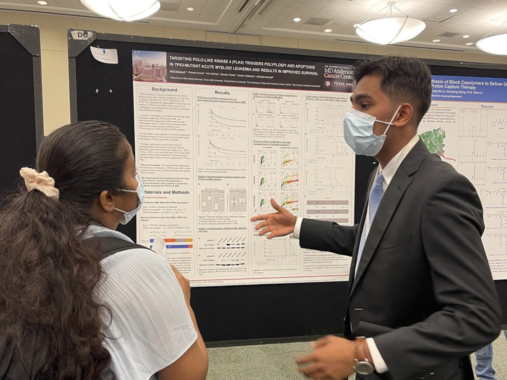 Marupudi explaining his poster to a viewer