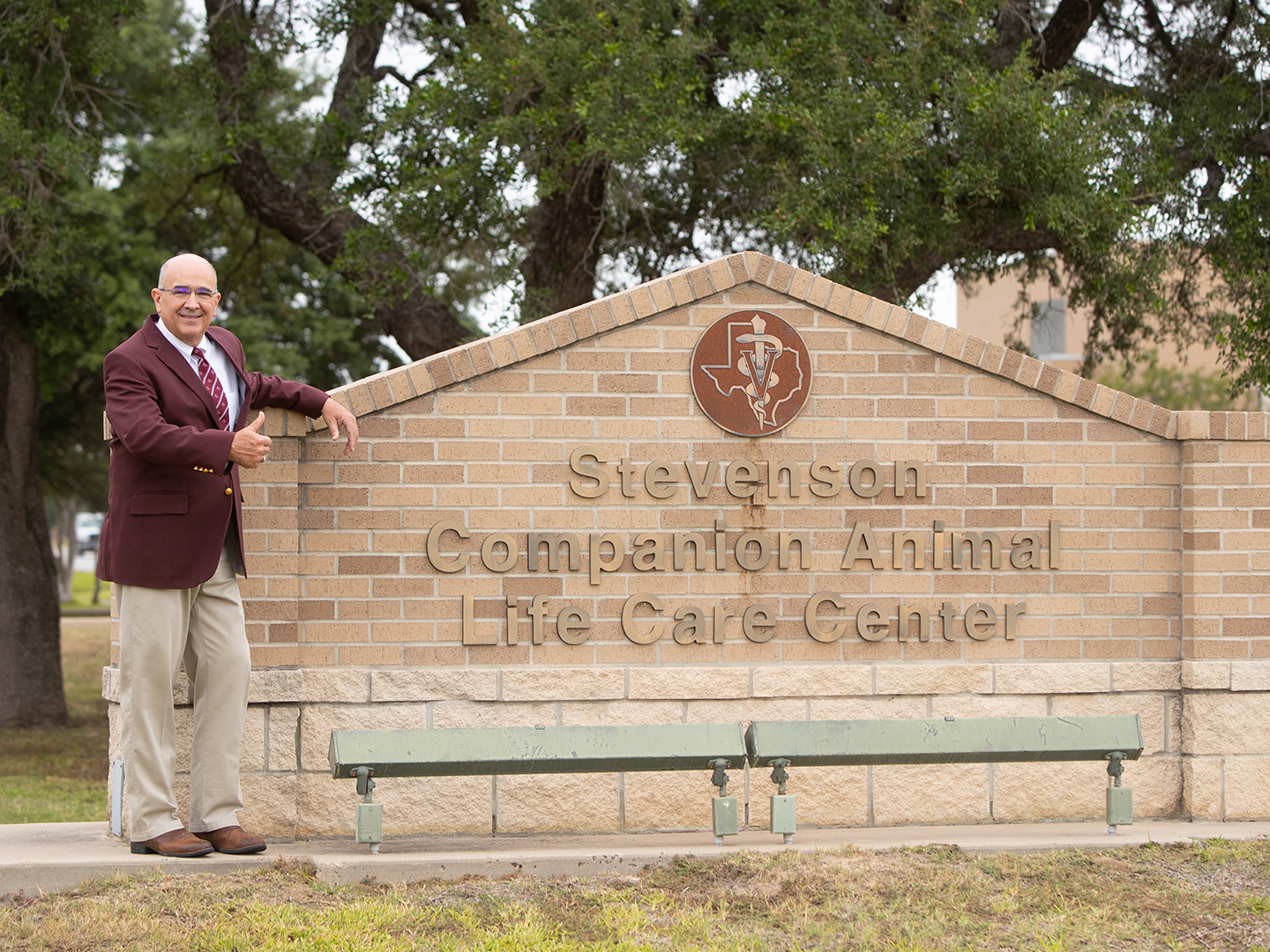 Dr. Sam Miller standing by the Stevenson Center sign