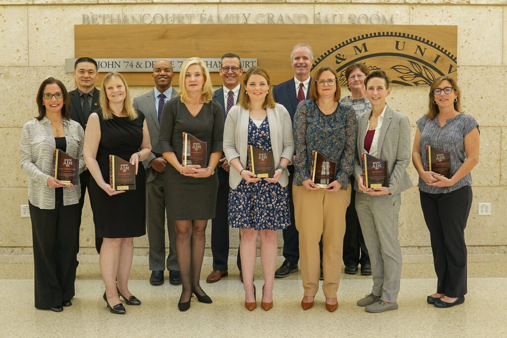 Group of award winners with their plaques