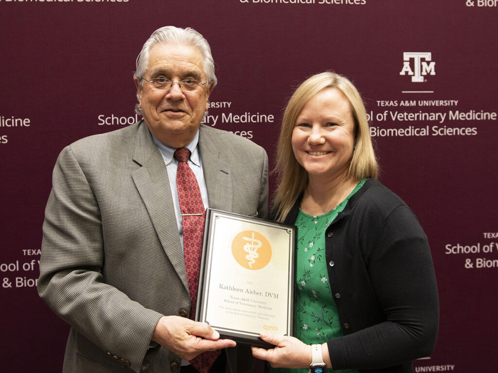 Dean August and Dr. Kate Aicher holding her award