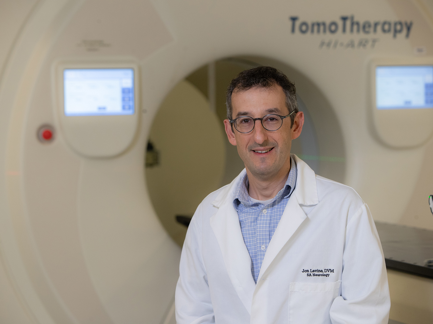 Dr. Jonathan Levine in front of a TomoTherapy machine