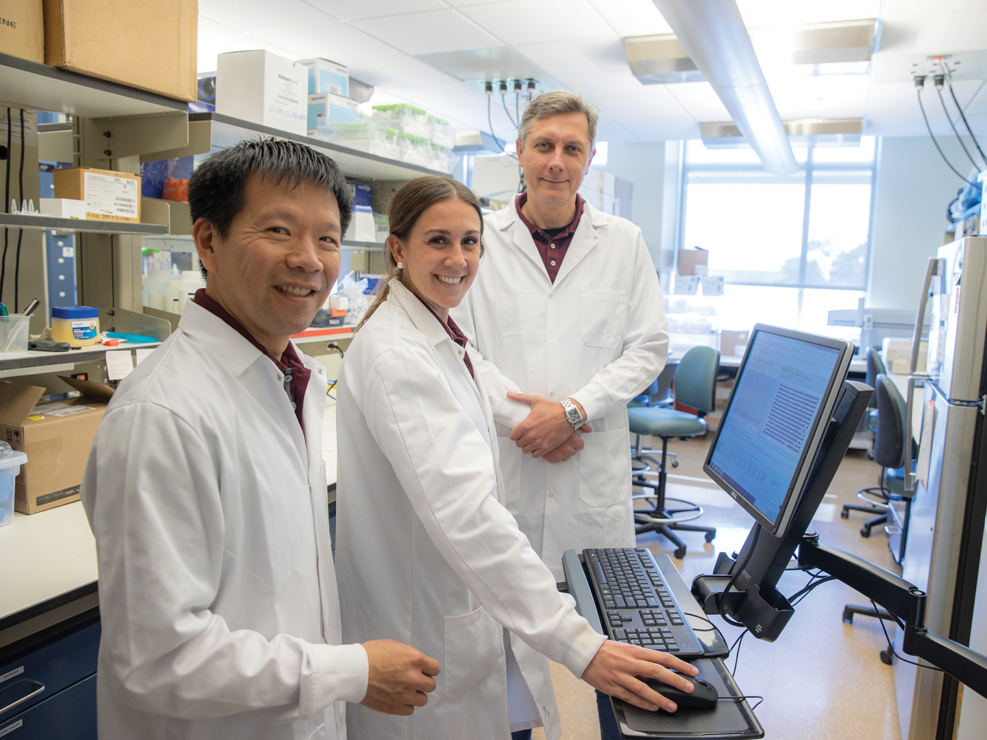 Three Superfund Center researchers working in a lab