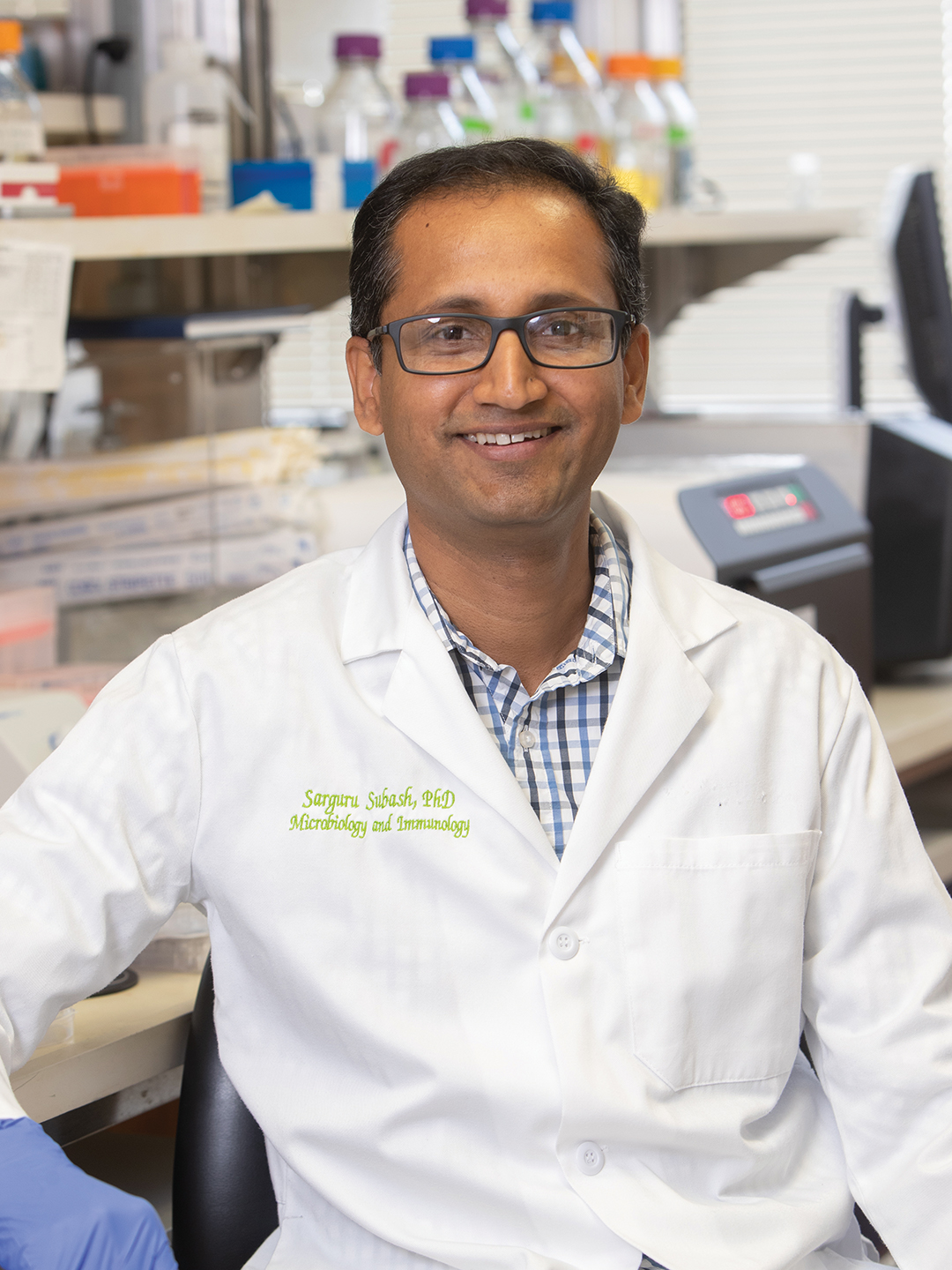Dr. Sarguru Subash in a white lab coat
