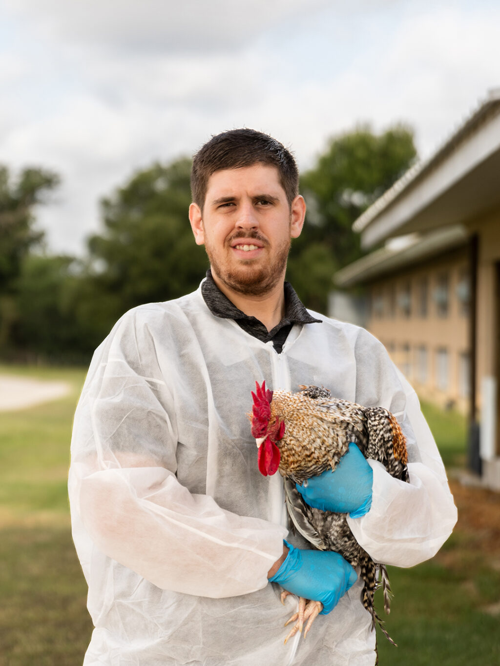 Nikolas Faust in PPE holding a rooster