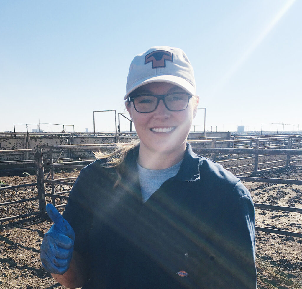 Ashlee Ambs as a student in front of a feedlot
