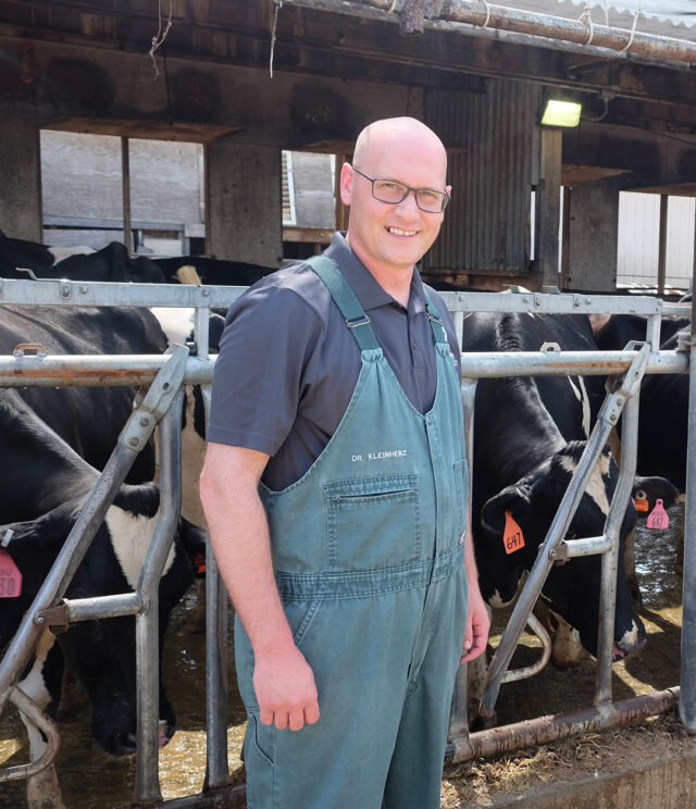 Dr. Michael Kleinhenz in front of a herd of dairy cattle