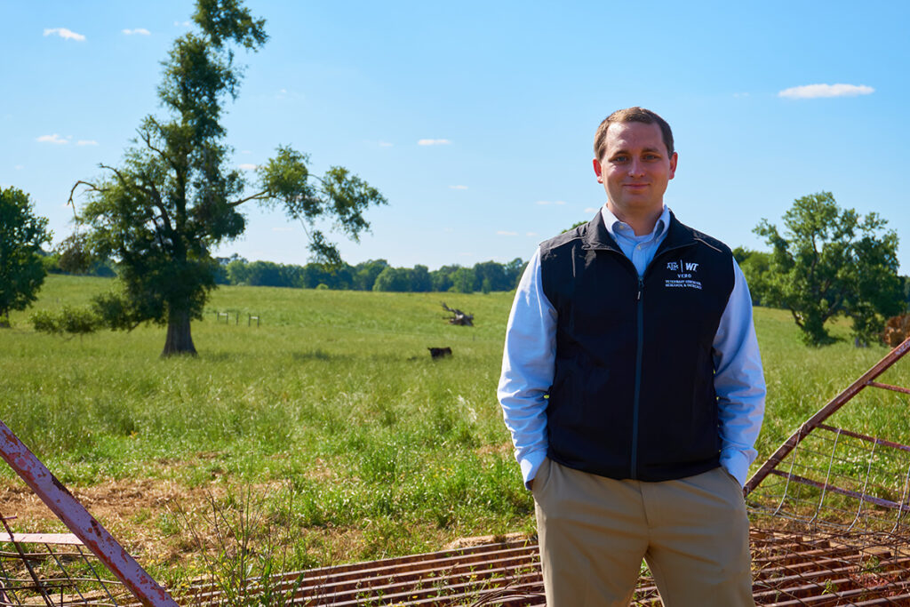 Dr. Matthew Scott in front of a field