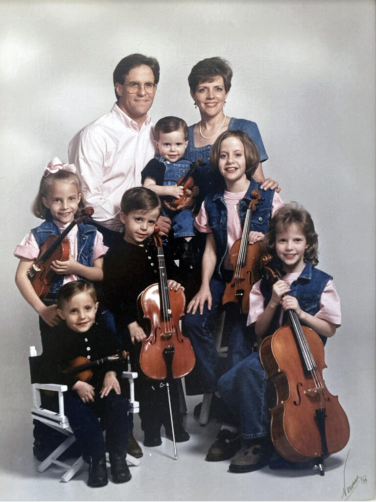 Two parents and six kids, all with string instruments