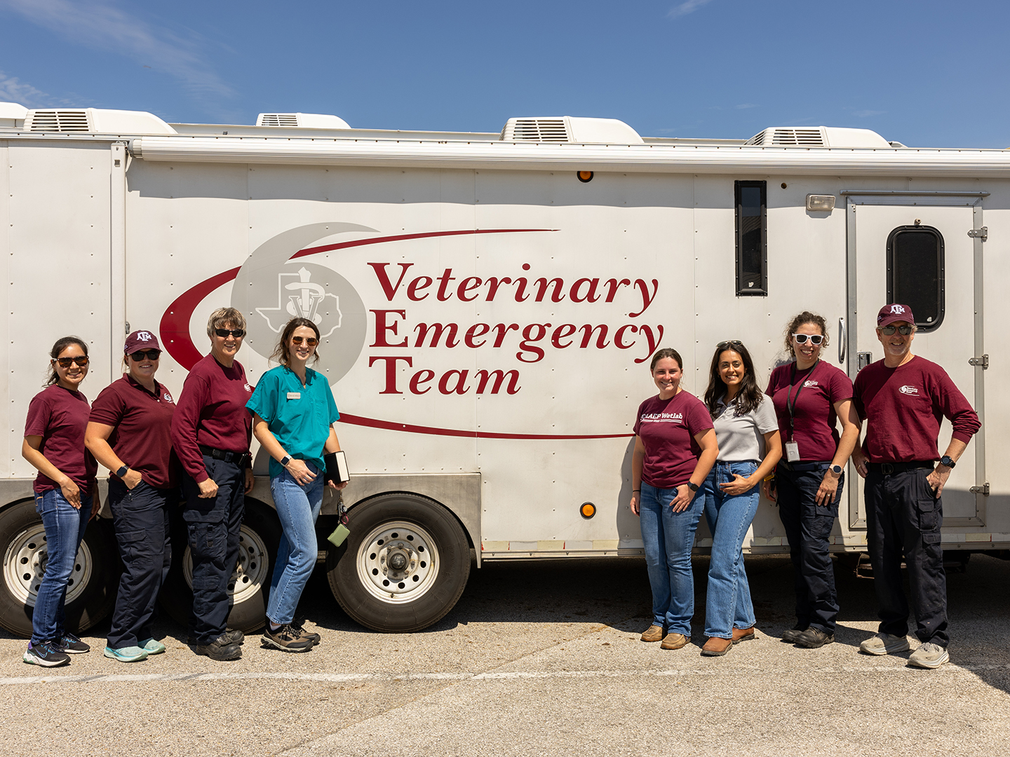 Eight people in front of the VET trailer