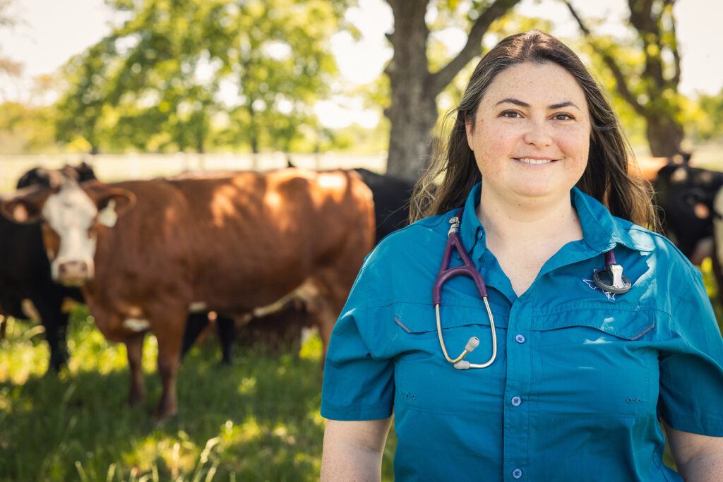 Jessica Stephenson in front of a field of catle