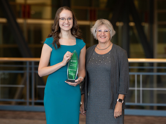 Shumaker holding her award, with Gaddy